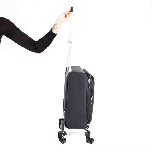 skyrider carry on luggage being held easily by one hand to demonstrate the light weight
