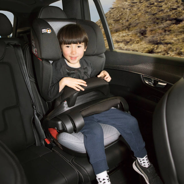 older kid sitting in comfortable Mountain Buggy  haven car seat safely buckled in using safeguard technology_default